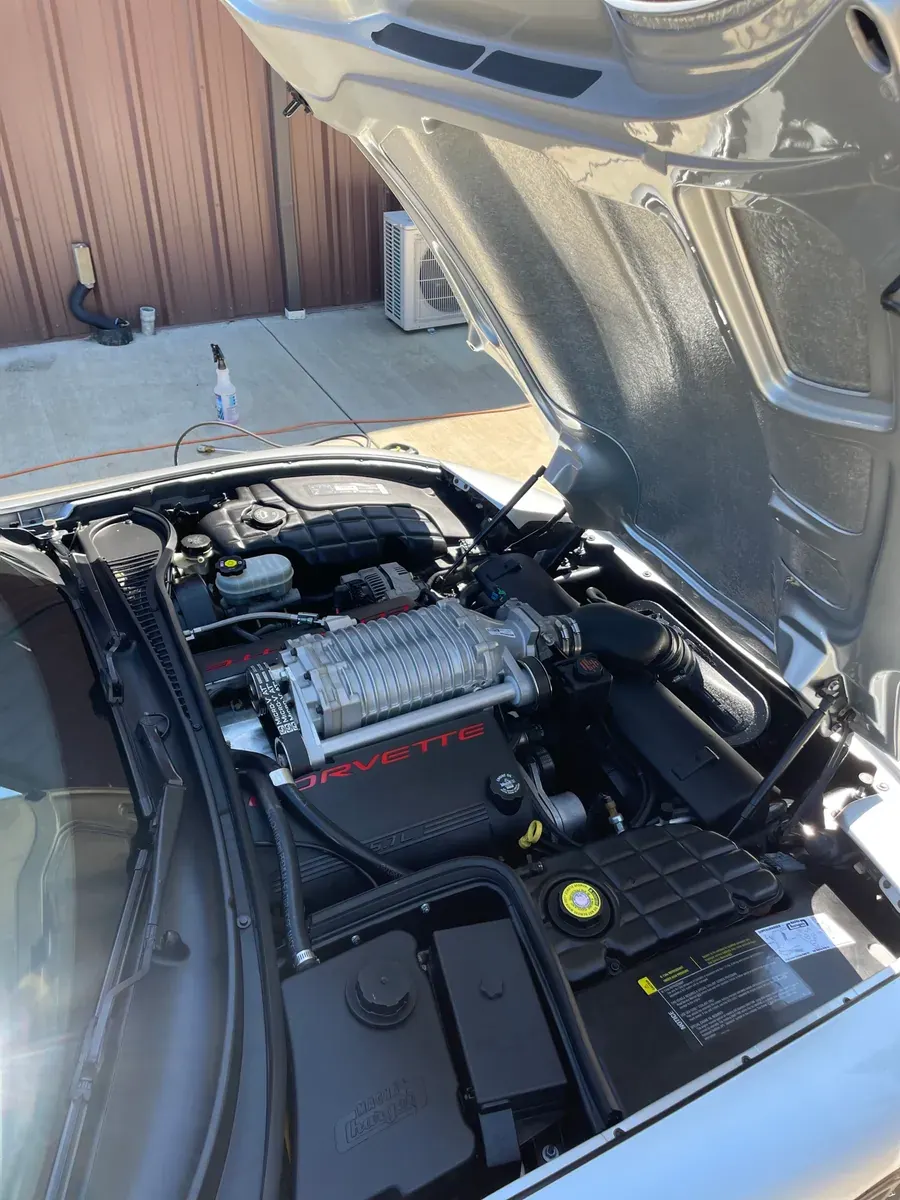 Supercharged Corvette engine bay with the hood up, cleaned and dressed