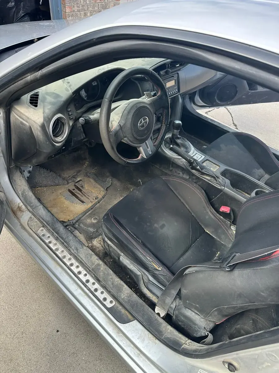 Before: Driver footwell and seat, interior detail